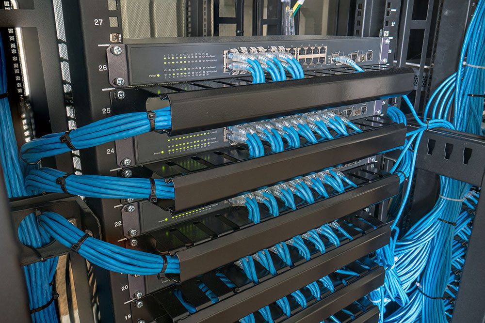 Server racks with panels holding well-organized cables