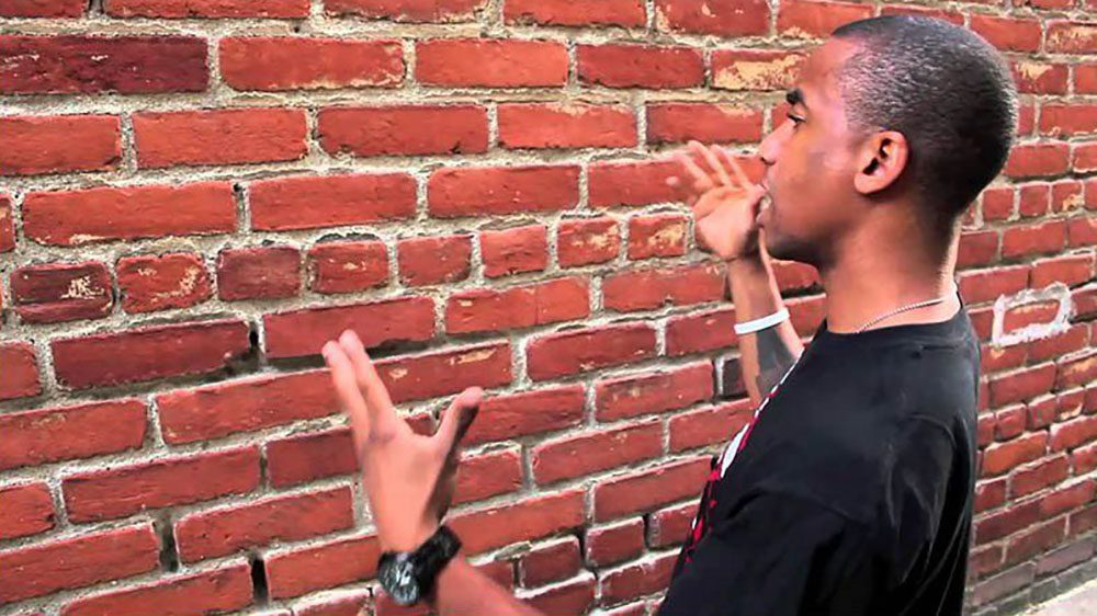 Man talking to a brick wall