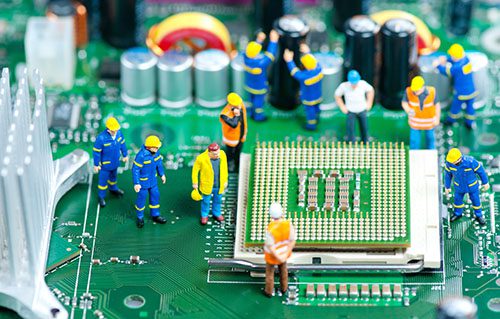 Miniature figures of engineers on CPU