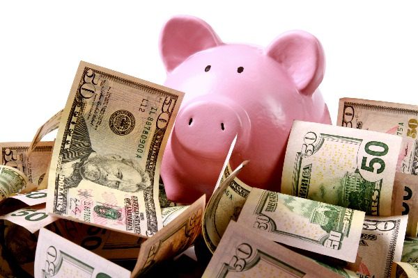 Piggy bank with cash around it