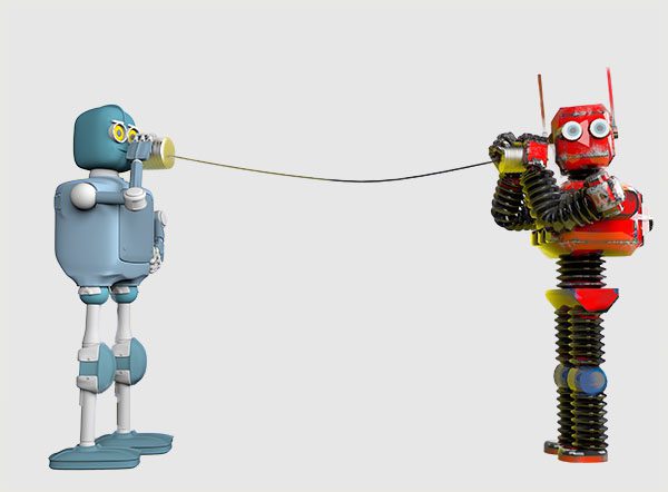 Two toy robots communicating with tin cans and string.