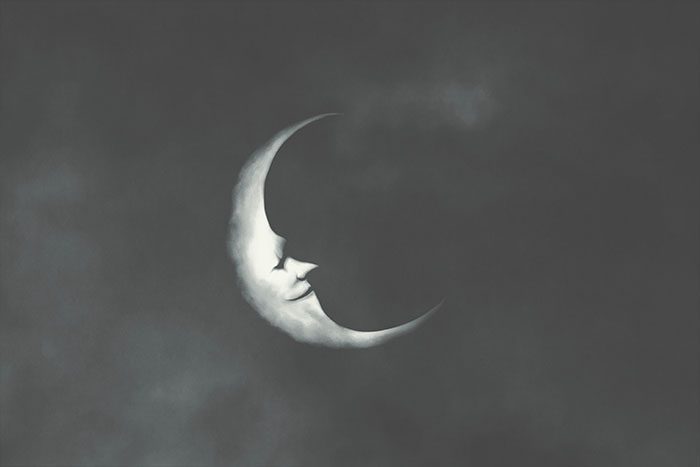 Drawing of a crescent moon with a smiling face in profile