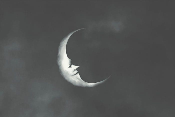 Drawing of a crescent moon with a smiling face in profile