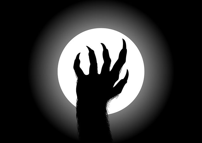 Drawing of werewolf hand with full moon behind it