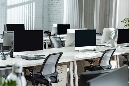 Empty office showing a lot of workstations with computers