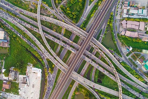 Aerial view traffic junction with highways, streets, overpasses and freeway