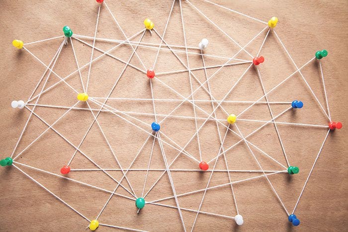 Push pins connected with thread.