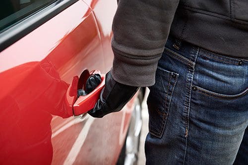Car thief checking to see if car door is unlocked