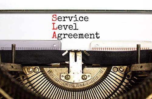 Service Level Agreement. Old typewriter with typed words stacked on top of each other so the first letters SLA, shown in red, stand out.
